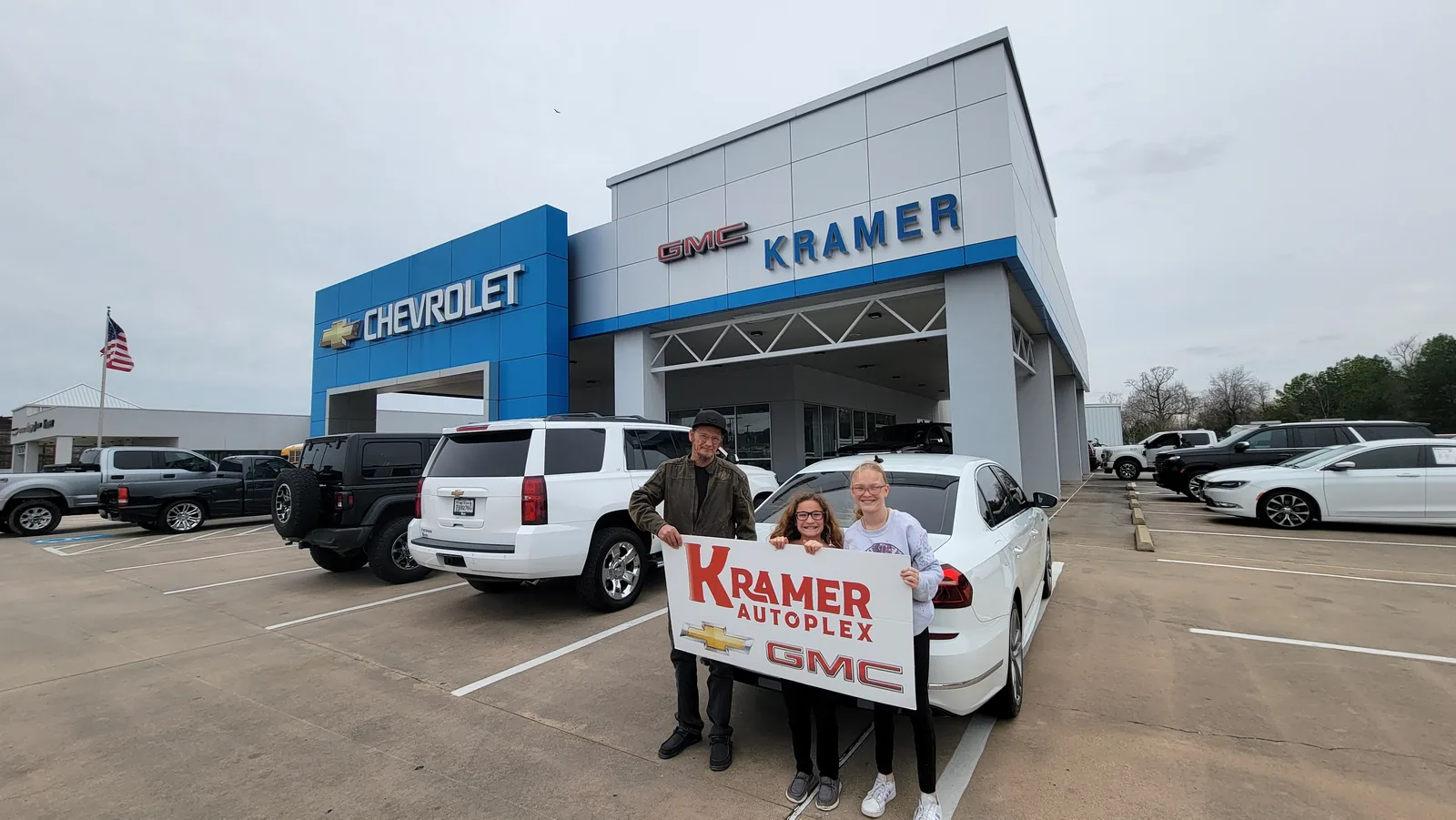 A family picking up their vehicle outside the dealership showroom